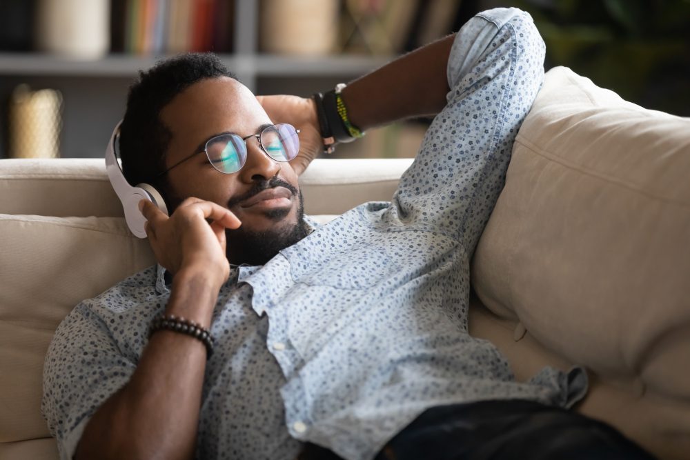 Man_Relaxing_With-Headphones